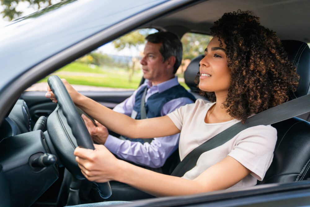 Woman driving car during lesson with instructor